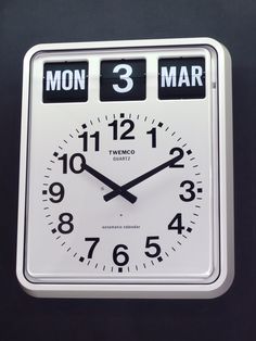 a white clock with black numbers on it