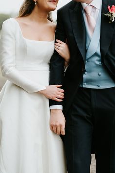 a bride and groom standing next to each other