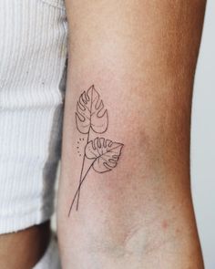 a woman's arm with a small tattoo on the left side of her arm