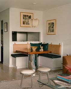 a living room filled with furniture next to a table and chairs on top of a hard wood floor