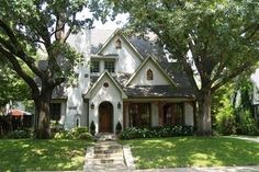 a white house with trees in the front yard