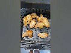 chicken wings are being cooked in an air fryer