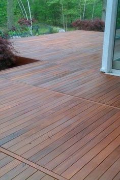 a wooden deck in front of a glass door