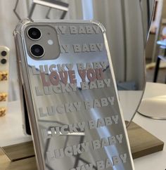 an iphone case with the words love you lucky baby on it sitting on a table