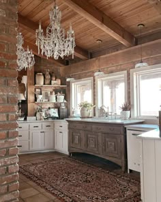 a kitchen with a chandelier hanging from the ceiling and an area rug on the floor