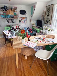 a living room filled with furniture and lots of clutter on top of wooden floors