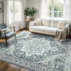 a living room with a couch, chair and rug