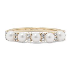 a gold ring with pearls and diamonds on the bottom, set in 18k yellow gold