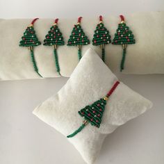 a white pillow with christmas tree decorations on it