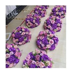 purple and pink flowers arranged on the floor