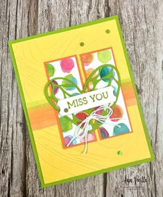 a close up of a card on a wooden surface with the words miss you written in it