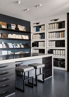 an office with two desks and several bookshelves