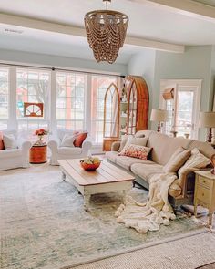 a living room filled with furniture and lots of windows