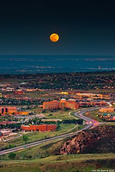 the full moon is seen over a city in this view from an aerial view point