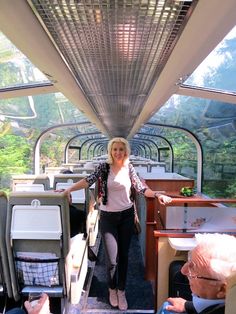 a woman standing on the inside of a bus