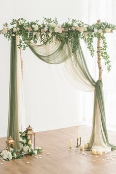 the wedding arch is decorated with greenery and candles