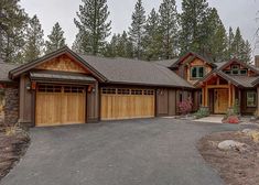 a large house with two garages in front of it