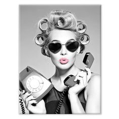 a woman with curly hair is holding an old phone and talking on the phone