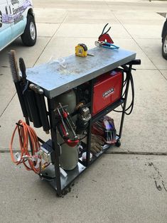 an air compressor sits on top of a cart