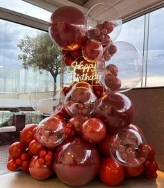 a birthday cake made out of red balloons