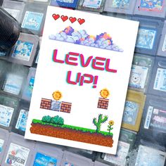 a sign that says level up in front of a bunch of video game playing cards