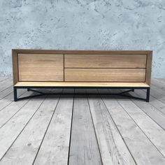 the sideboard is made out of wood and metal, with an open drawer underneath it