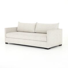 a white couch sitting on top of a white floor