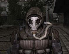 a man wearing a gas mask and holding a pipe