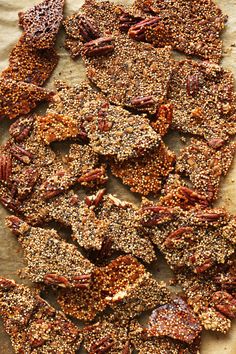 quinoa brittles are arranged on a piece of parchment paper with the words quinoa brittle over them