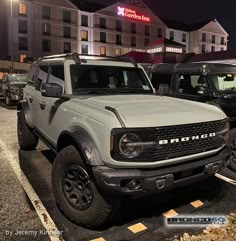 several trucks parked in a parking lot at night