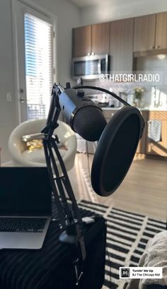 a microphone and laptop on a table in a room