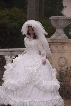 a woman in a white wedding dress and veil