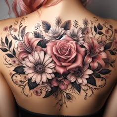 a woman's back with flowers and leaves on it