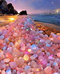 the beach is covered in many different colored rocks and pebbles, along with stars above