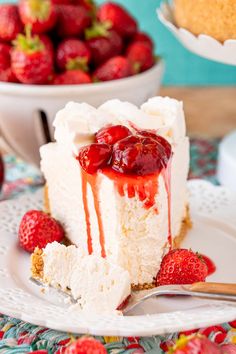 a slice of cheesecake with strawberries on the side