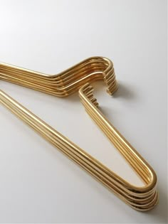 a gold colored metal object on a white surface