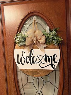 a welcome sign hanging on the front door