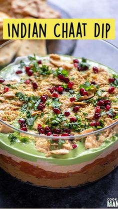 a dessert dish with cranberries and nuts in it on a table next to crackers