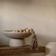 a bowl filled with eggs sitting on top of a wooden table