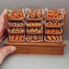 a wooden box filled with lots of different types of doughnuts and pastries