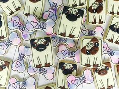 many decorated cookies with different designs on them are displayed in the shape of dogs and hearts