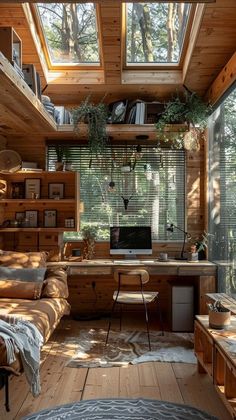 a bedroom with wooden walls and flooring has a desk in the corner, windows above it