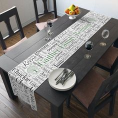 a dining room table with place settings and fruit on the plate, in front of it