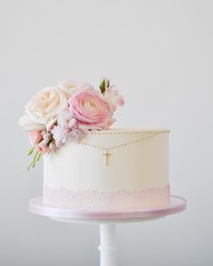 a white cake with pink flowers on top