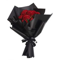 a bouquet of red roses wrapped in black paper