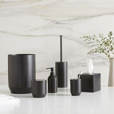 the bathroom accessories are all in black and white colors, including soap dispensers