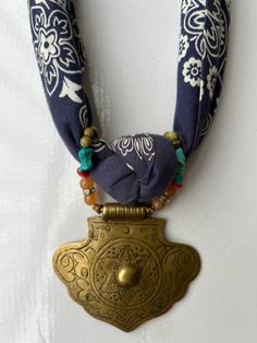 a gold medal with a blue ribbon around it's neck and an ornate design on the front