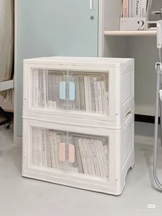 two white plastic storage boxes sitting next to each other