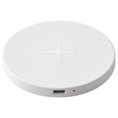 an electronic device with a white cross on the front and back side, sitting on a white surface