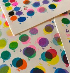 several different colored dots on white paper